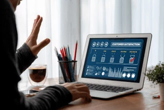 a man seeing some graphs and charts on the laptop screen seems like having a look to revenue chart
